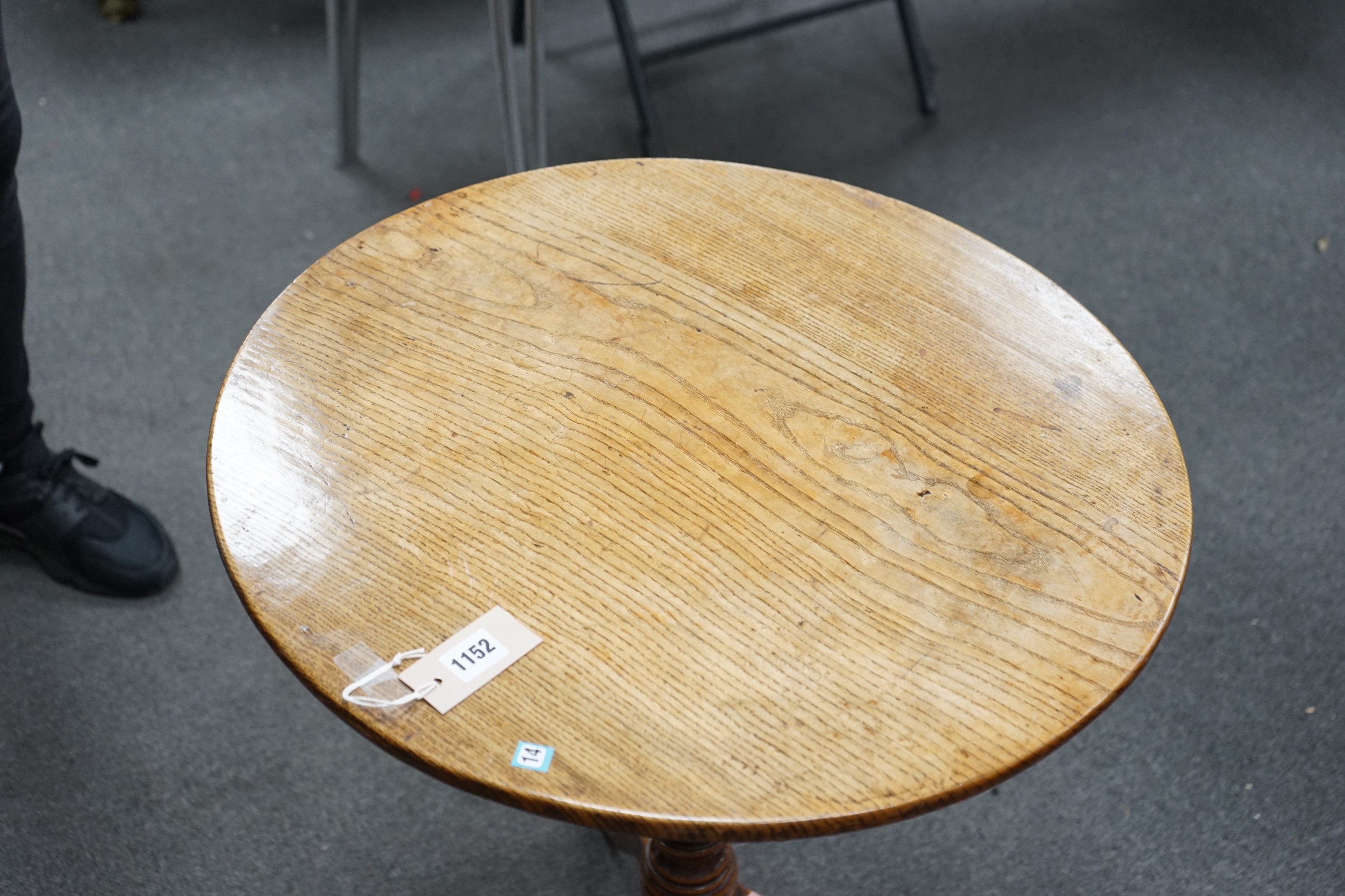 A George III circular oak tripod tilt top tea table on turned column, diameter 58cm, height 67cm